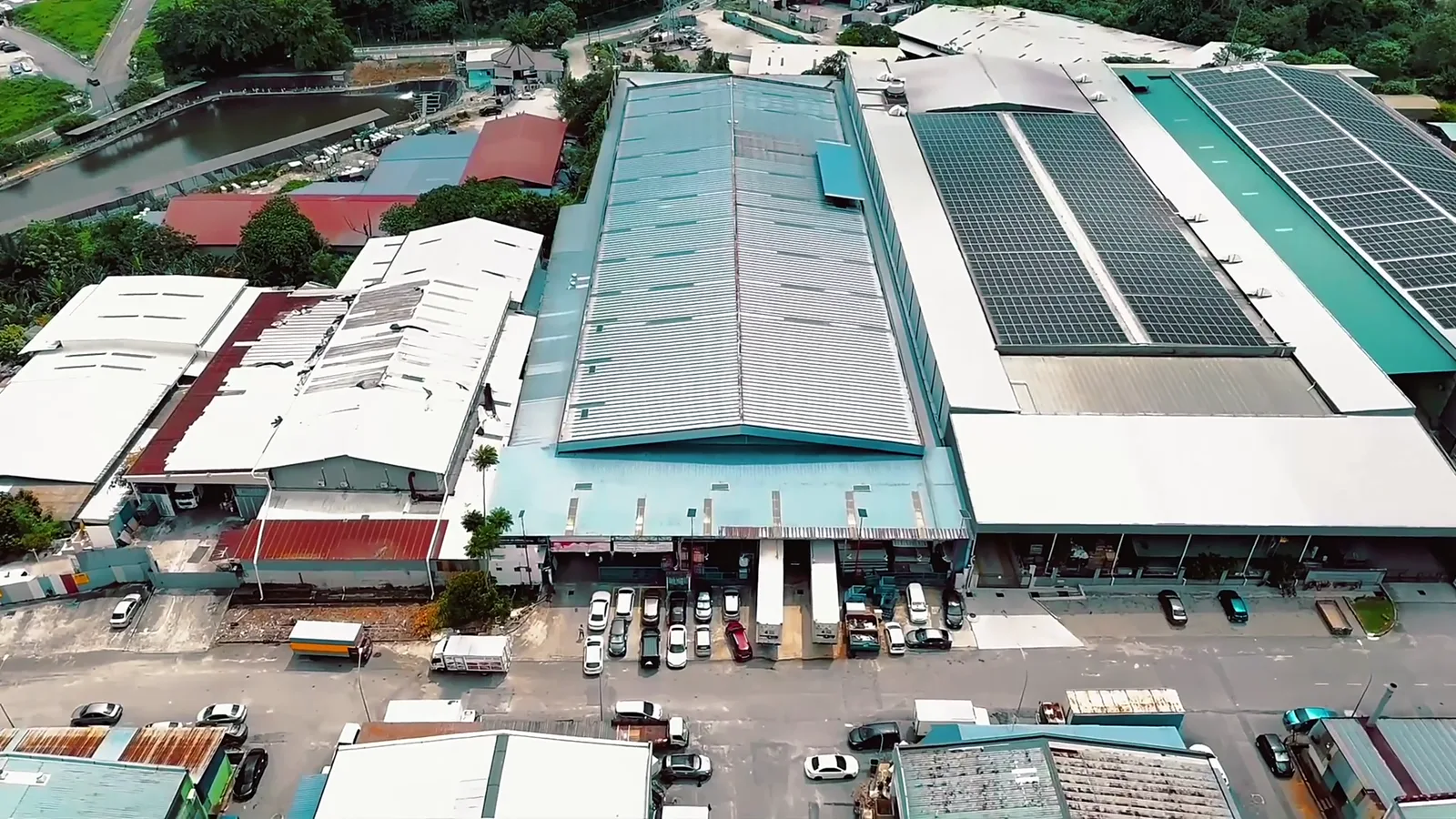 Aerial view of the Arctic cold-storage facility, warehouses with solar roofs and loading bays lined with refrigerated trailers